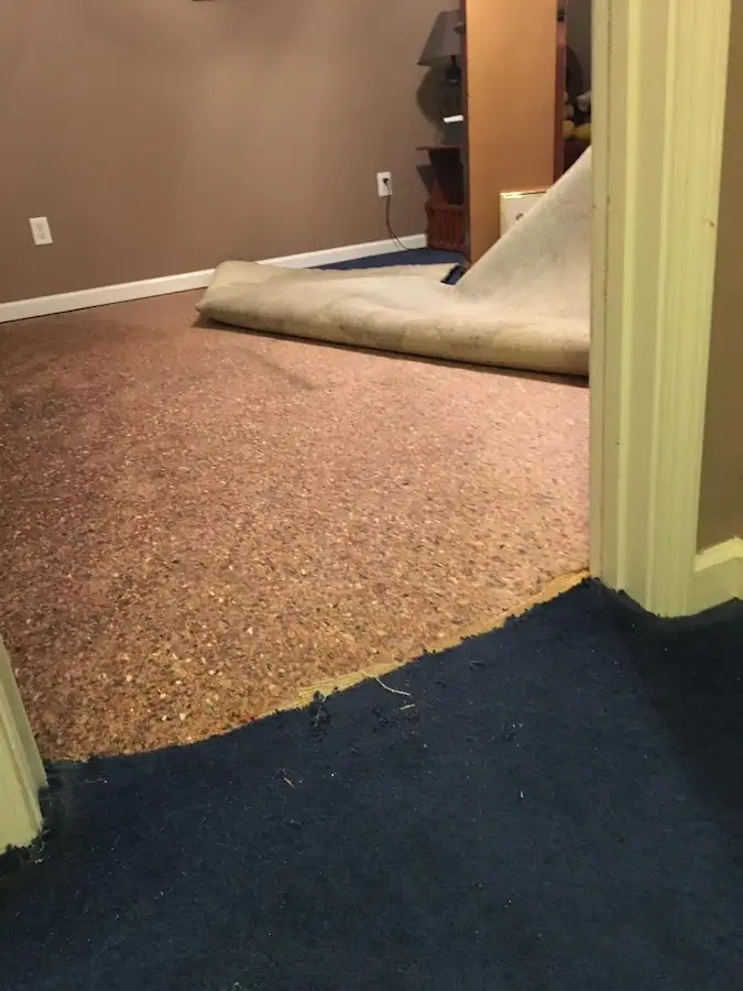 Carpet pad removal revealing water damage during Water Mitigation Services in Chambersburg
